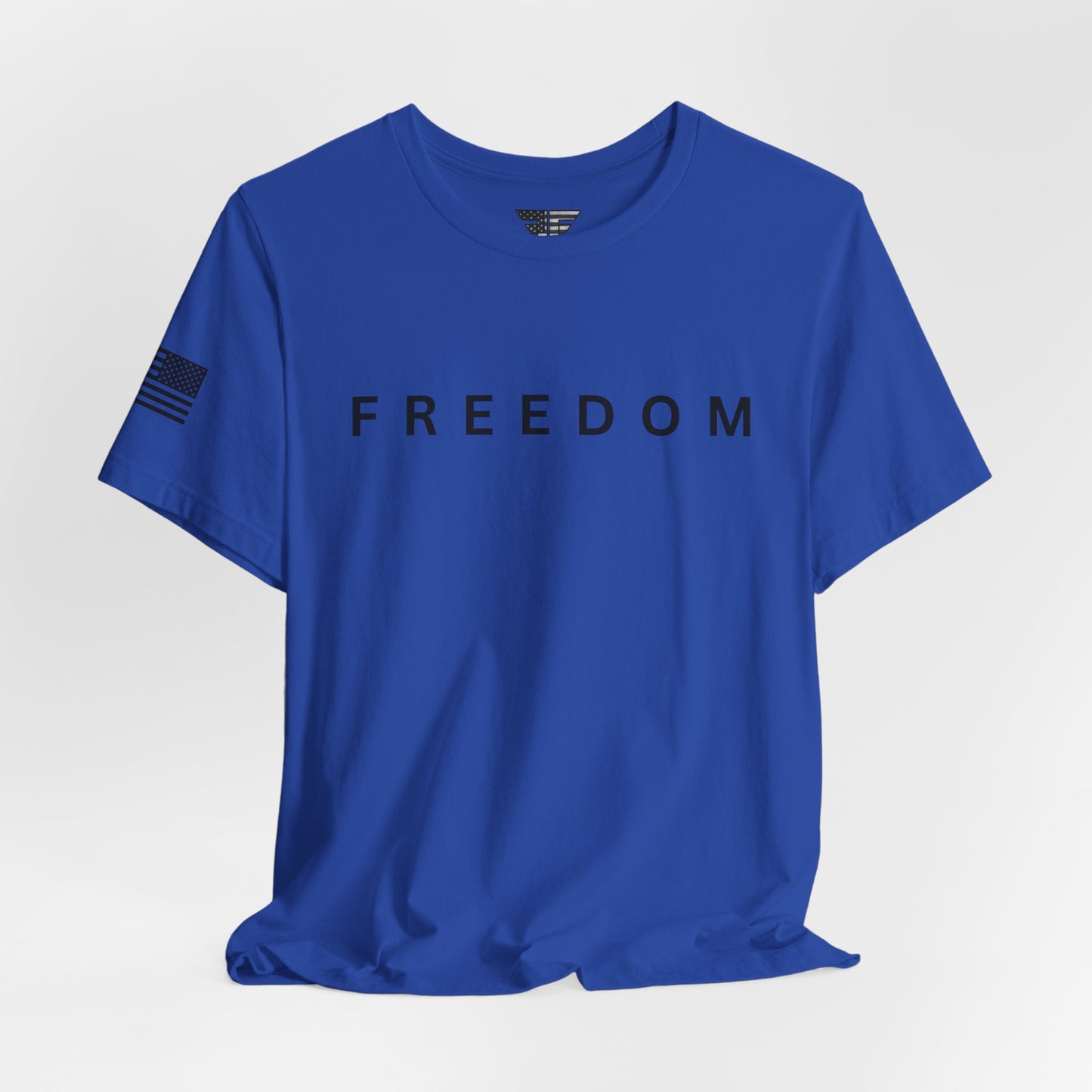 Blue t-shirt with 'FREEDOM' printed on it against a light gray background