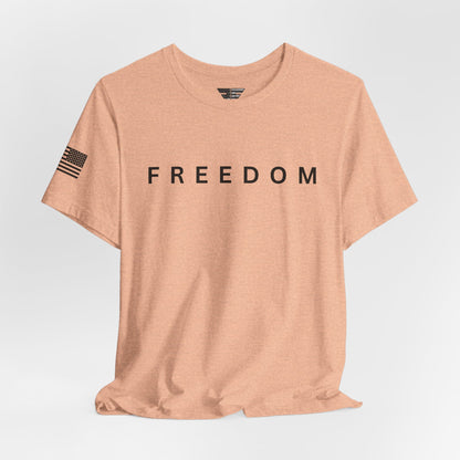 Beige t-shirt with 'FREEDOM' printed on it against a light gray background