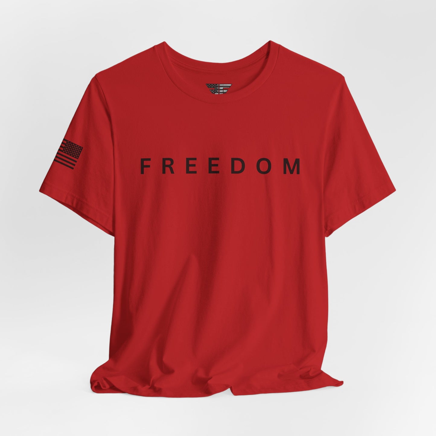 Red t-shirt with 'FREEDOM' printed on it against a white background