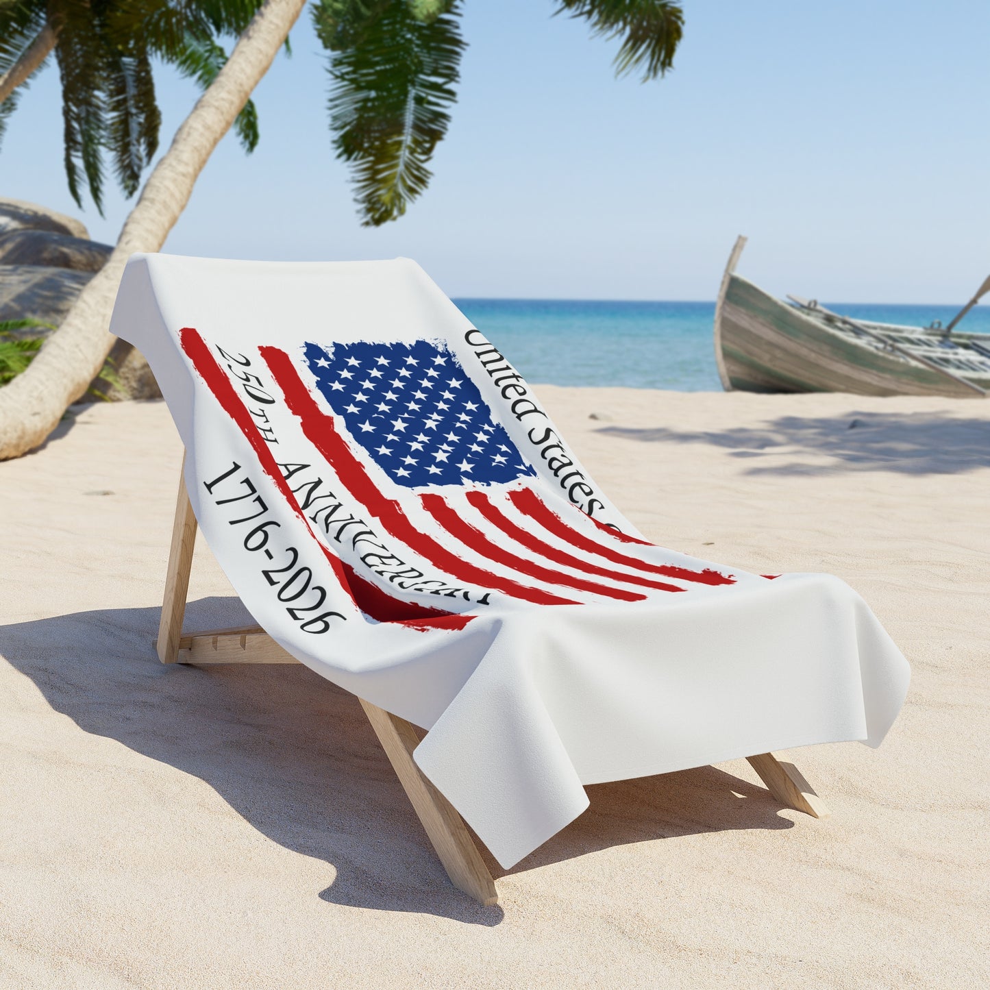Beach chair with a towel featuring the American flag on a sandy beach with palm trees and a boat in the background.