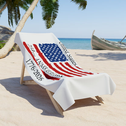 Beach chair with a towel featuring the American flag on a sandy beach with palm trees and a boat in the background.