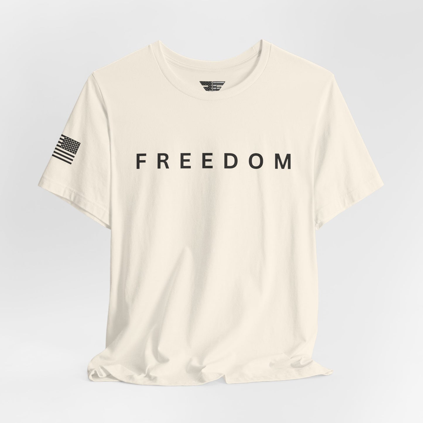 Beige t-shirt with 'FREEDOM' text on a light gray background