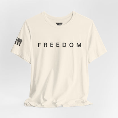 Beige t-shirt with 'FREEDOM' text on a light gray background