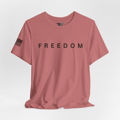 Pink t-shirt with 'FREEDOM' text on a light gray background