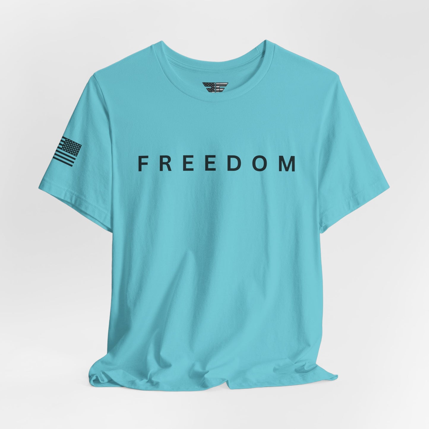 Light blue t-shirt with 'FREEDOM' printed on it against a light gray background