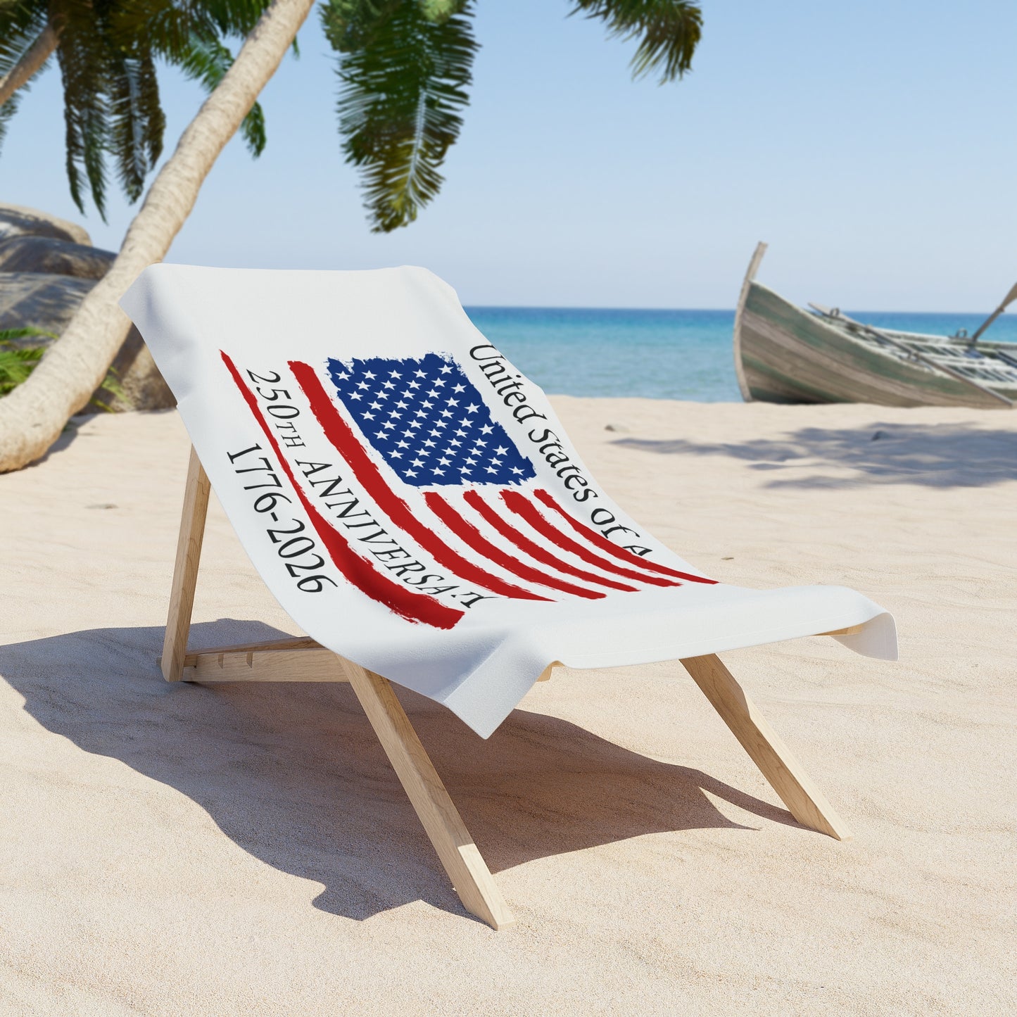 Beach towel with American flag design and text on a sand chair at a beach.