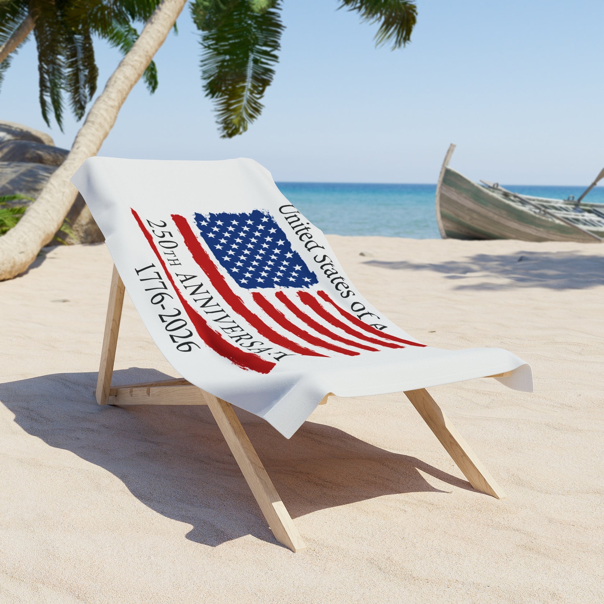 Beach towel with American flag design and text on a sand chair at a beach.