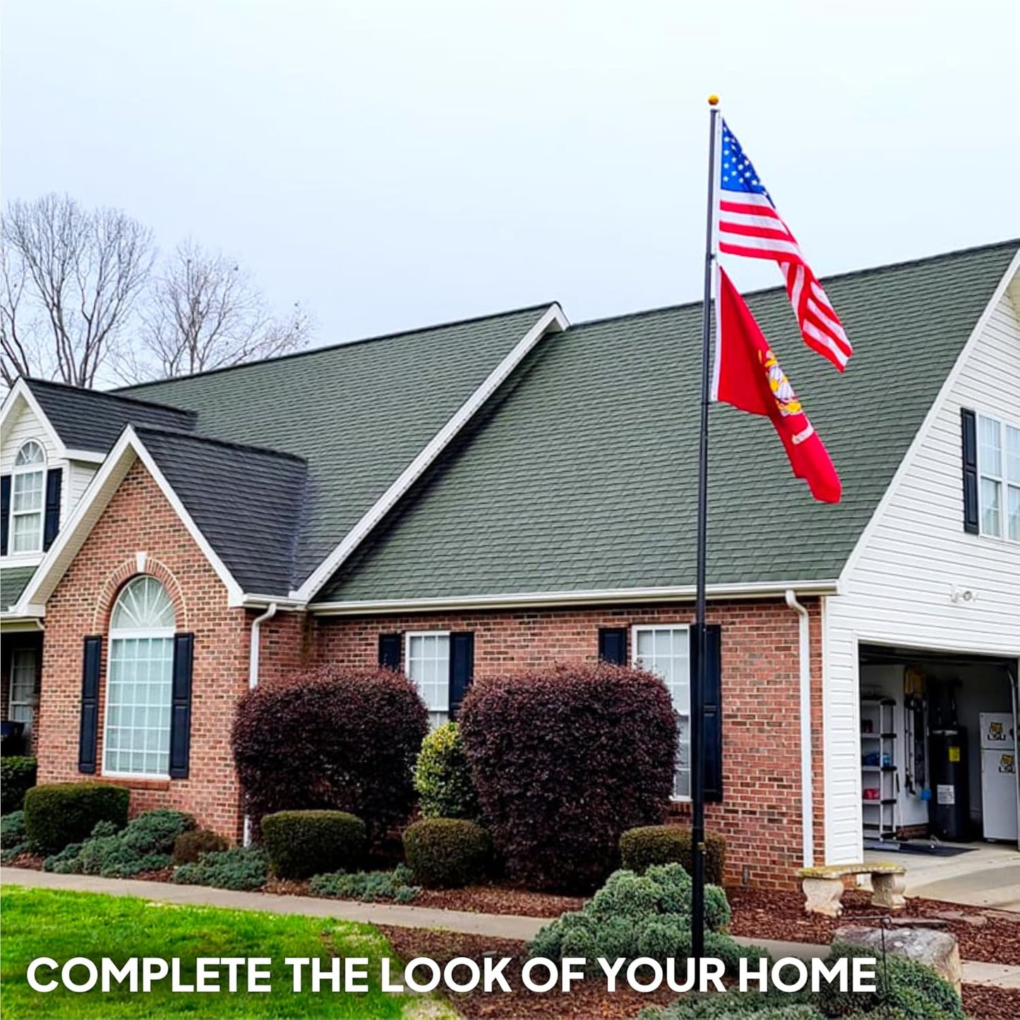 Two-story house with American and state flags on a clear day