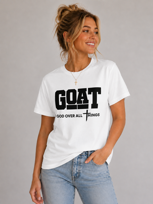 Woman wearing a white t-shirt with 'GOAT God Over All Things' text on a gray background