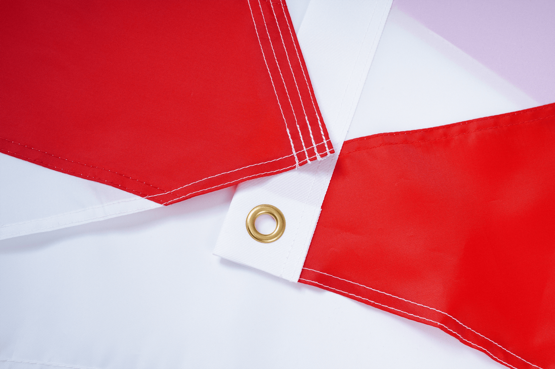 Red flags with grommets on a white background