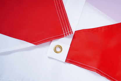 Red flags with grommets on a white background