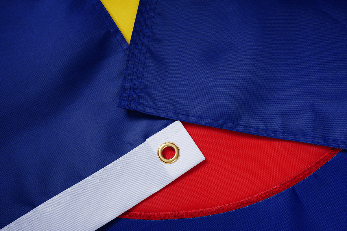 Close-up of a flag with blue, red, and yellow colors.