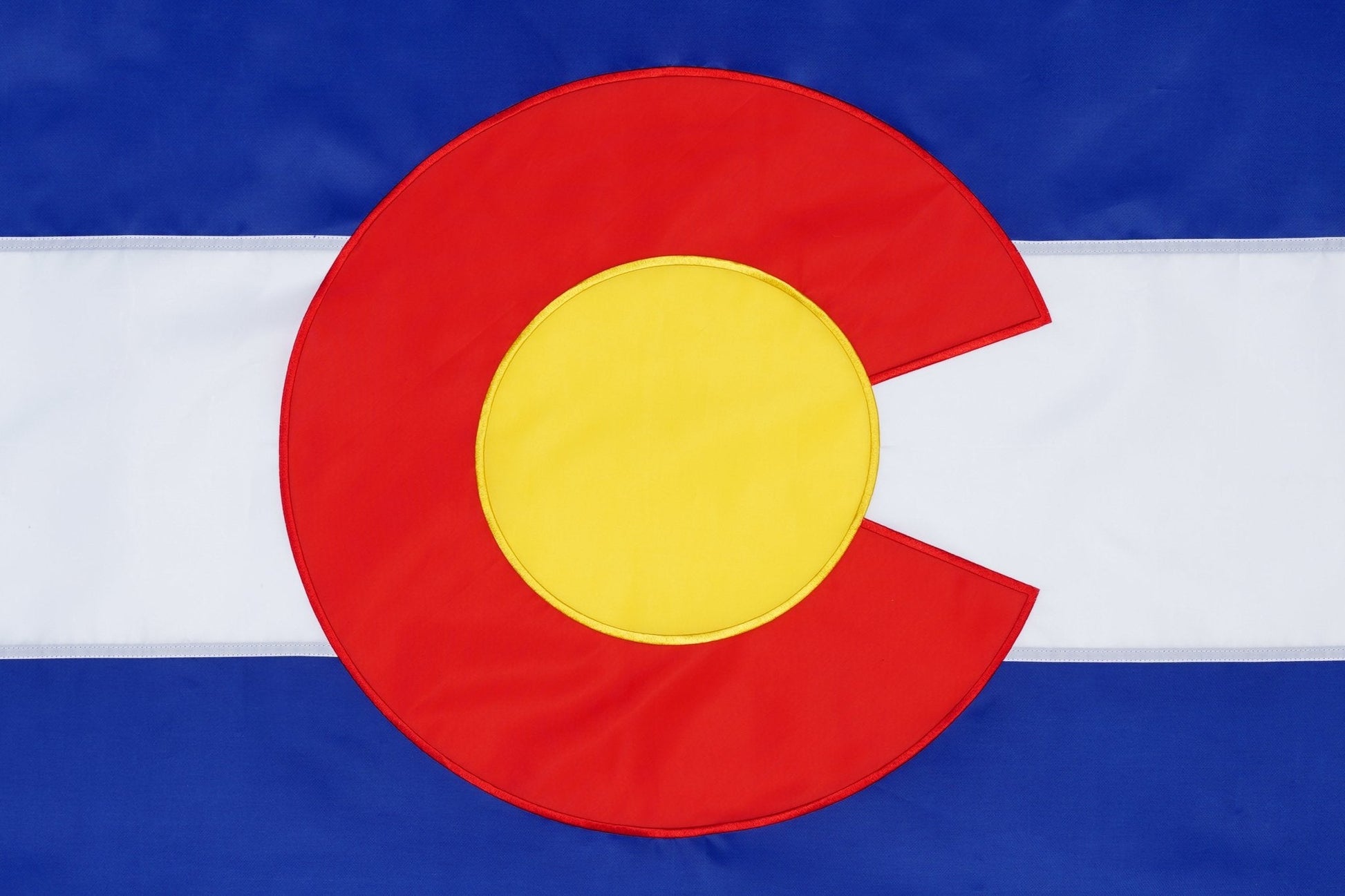Flag with a red circle and yellow center on a blue and white background