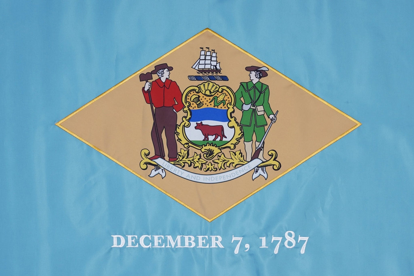 Flag of Delaware with coat of arms and founding date on a blue background