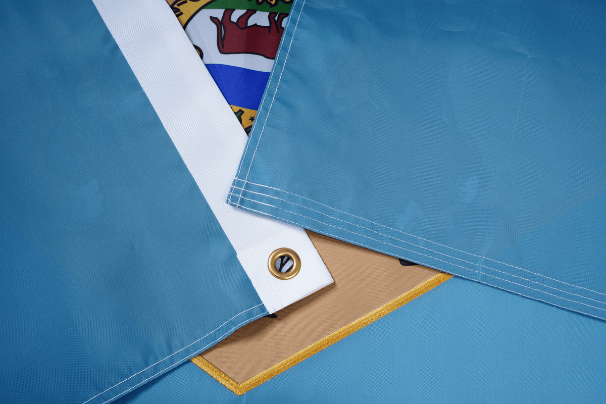 Close-up of a blue tarp with a white corner and colorful logo in the background