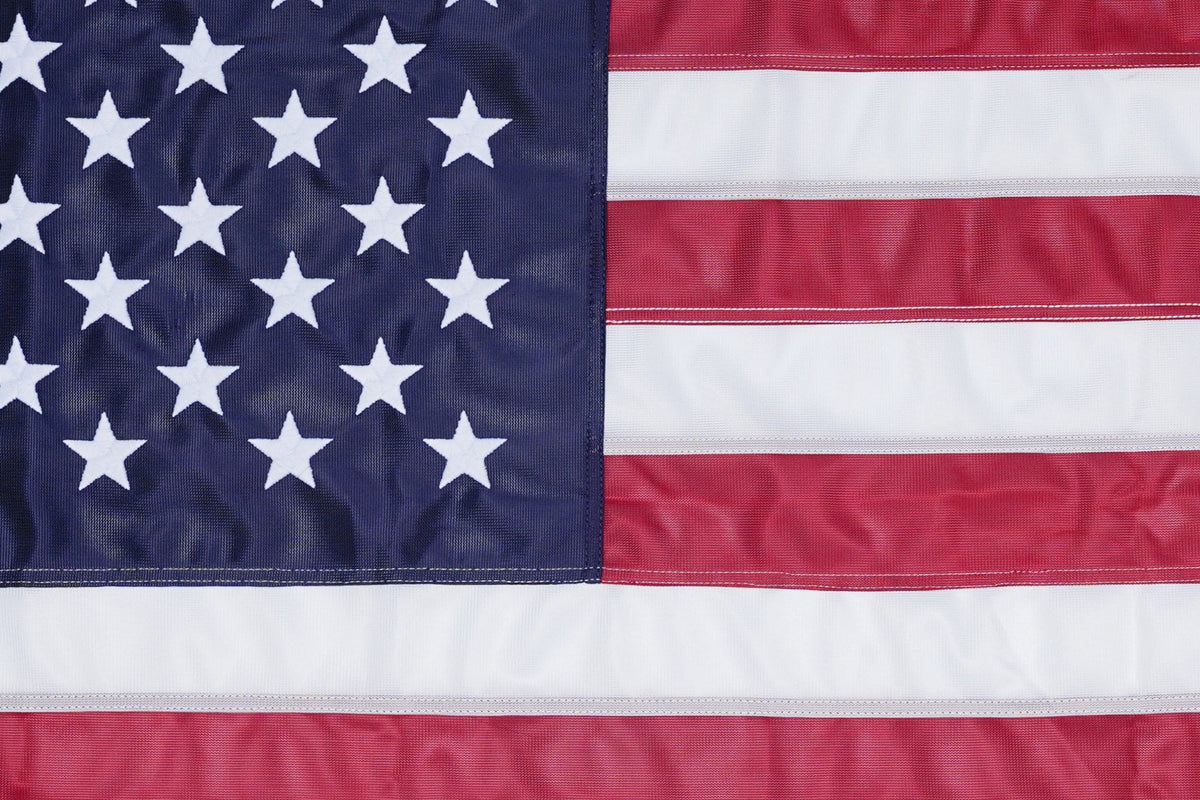 Embroidered stars and sewn stripes on knitted American flag